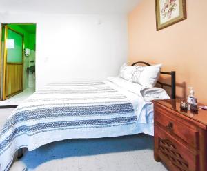 a bedroom with a bed and a wooden dresser at Nice bedroom at 5 min Mexico City Airport T1 & T2 in Mexico City +2 photos