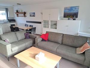 a living room with two couches and a table at Holiday home in Breskens with Wi-Fi in Breskens