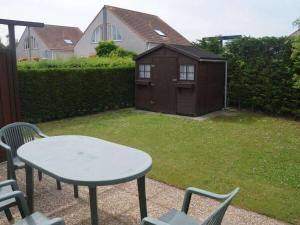 a table and chairs in a yard with a smallshed at Holiday home in Breskens with Wi-Fi in Breskens