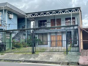 a blue and white house with a gate at Rous place# 2 in Fortuna