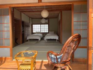 a room with two beds and two chairs at MYOJI HOUSE 2 Traditional Japanese Stay in Katsuragi