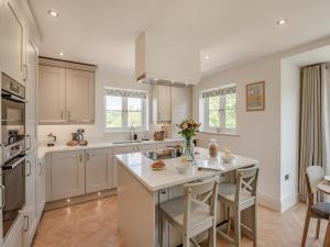 a kitchen with white cabinets and a large island at Whistle Stop in Whitby