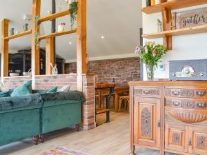 a living room with a couch and a table at The Coach House in Blencogo