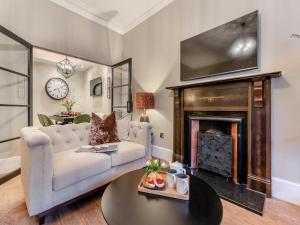 a living room with a couch and a fireplace at Old Bank House in Barnard Castle