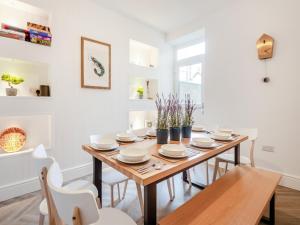 a dining room with a wooden table and chairs at Townhouse in Llandudno