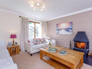 a living room with a couch and a fireplace at The Lookout in Aviemore