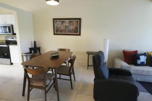 a kitchen and living room with a table and chairs at Waterview Dream in Vamo +46 photos
