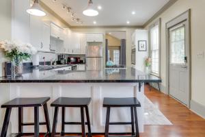 a kitchen with a large island with two bar stools at Franklin Home with Deck, Creek Views Walk to Shops in Franklin