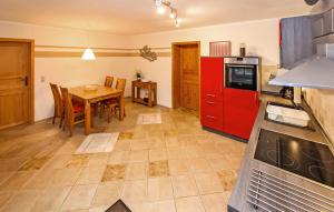 a kitchen with a table and a red refrigerator at Ferienwohnung Userin in Userin