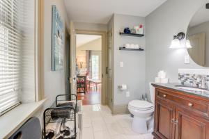 a bathroom with a toilet and a sink at Franklin Home with Deck, Creek Views Walk to Shops in Franklin +17 photos