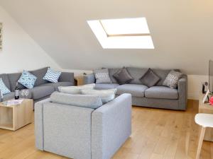 a living room with a couch and a chair at Lyndhurst in Perranporth