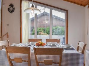a dining room table with a bowl of fruit on it at Serenity in Millom