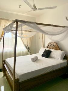 Cama ou camas em um quarto em Kivutio cha pwani