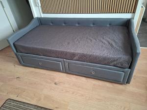 a blue dog bed sitting on a floor at Stieber in Sangerhausen +2 photos