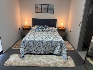 a bedroom with a large bed with two night stands at Casa Malu in Bertioga +101 photos