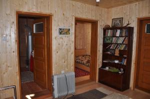 a room with a bed and a book shelf at Küküllő Vendégház in Sovata