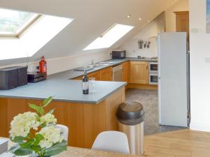 a kitchen with skylights and a kitchen with a counter at Lyndhurst in Perranporth +16 photos