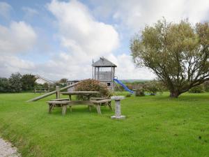 a park with a picnic table and a playground at The Old Mill House in Welcombe