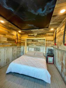 a bedroom with a bed in a room with wooden walls at Lake Therapy at The ARK | Gameroom, Hot Tub, Dock in Williamstown +58 photos