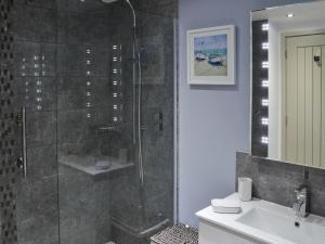 a bathroom with a shower and a sink at Little Tregarthen in Padstow +12 photos