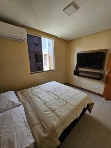 Un dormitorio con una cama y un televisor de pantalla plana. en Acomodação Ideal Samambaia, en Ananindeua 9 fotos más