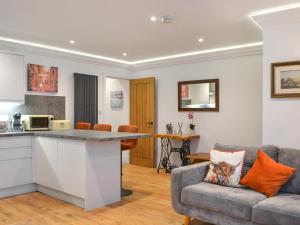 a kitchen and a living room with a couch at The Wharfe - Flat 1 - Uk49411 in York