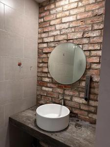 a bathroom with a white sink and a mirror at VY DA CENTRAL MARKET HOSTEL in Ho Chi Minh City