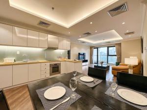 a kitchen and living room with a table and chairs at Skyline Tower - Service Apartments in Hanoi