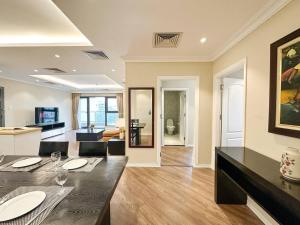 a dining room and living room with a table and chairs at Skyline Tower - Service Apartments in Hanoi