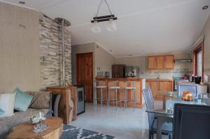 a living room with a couch and a kitchen at Lodge Rio Encantado, Pucon in Pucón