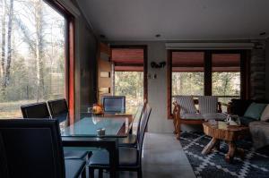 a living room with a table and a couch at Lodge Rio Encantado, Pucon in Pucón