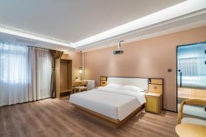 a hotel room with a bed and a desk at Floral Hotel Beijing Heyuan Courtyard Luxury Hotel in Beijing