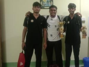 a group of three men standing with their trophies at SKY VIEW Home Stay in Siliguri
