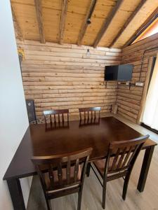 a dining room table with two chairs and a television at Piedras Blancas in La Bajada +9 photos