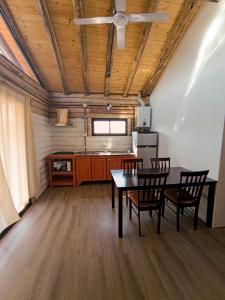 a kitchen with a table and chairs in a room at Piedras Blancas in La Bajada