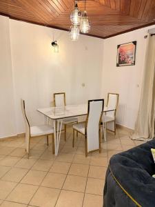 a dining room with a table and chairs at J&R business sarl in Douala