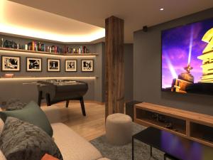 Μια τηλεόραση ή/και κέντρο ψυχαγωγίας στο Chalet d'exception aux 3 Vallées, 14 pers, jacuzzi, sauna - FR-1-452-399