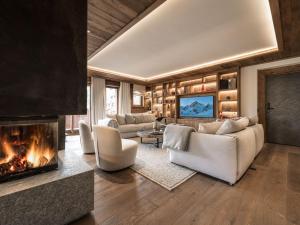 a living room with couches and a fireplace at Appartement haut de gamme à Courchevel Le Praz avec parking et wifi - FR-1-568-58 in le Praz