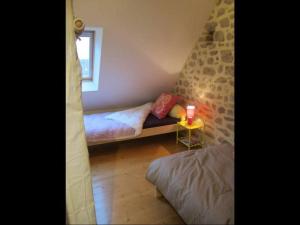 a small room with two beds and a window at Gîte au charme de la pierre et des poutres près de Guérande - FR-1-306-1317 in Clis
