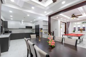 a kitchen and dining room with a table with a pool table at Kai Verde Villa in Ho Chi Minh City +43 photos
