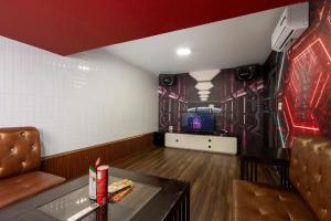 a room with a table and a tv on a wall at Kai Verde Villa in Ho Chi Minh City