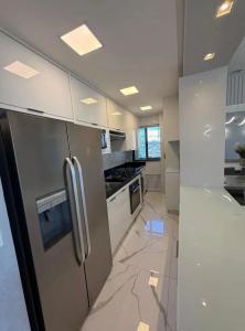a kitchen with stainless steel appliances and marble floors at apartamento luxo Umarizal in Belém +5 photos