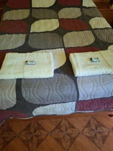 a bed with two towels on top of it at Apartamento Familiar Tacna Bonita in Tacna +7 photos