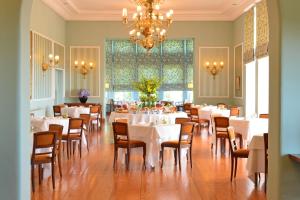a dining room with white tables and chairs and a chandelier at Pousada de Viana do Castelo in Viana do Castelo