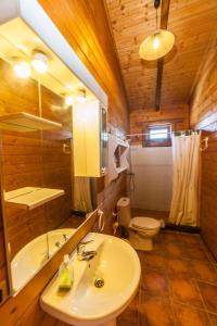 a bathroom with a sink and a toilet and a tub at Rural Tarifa Beach Las Cabañas in Tarifa