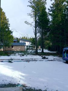 a snow covered parking lot with a bus parked at Morada entre Valles in San Carlos de Bariloche
