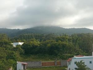 a view of a mountain with a fence and trees at Silicon Valley Residency in Yelagiri