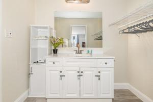 a white bathroom with a sink and a mirror at 2050 E IRLO BRONSON 1BED in Kissimmee