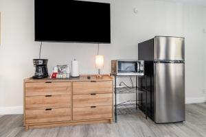 a kitchen with a stainless steel refrigerator and a microwave at 2050 E IRLO BRONSON 1BED in Kissimmee