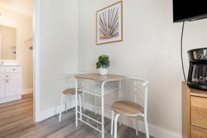 a kitchen with a small table and two stools at 2050 E IRLO BRONSON 1BED in Kissimmee